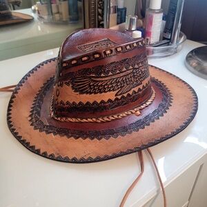 Brown Leather Cowboy Hat with Wide Brim and Decorative Band